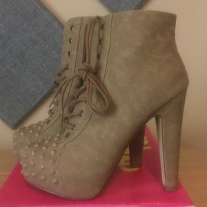 Spike toe high heeled lace up booties